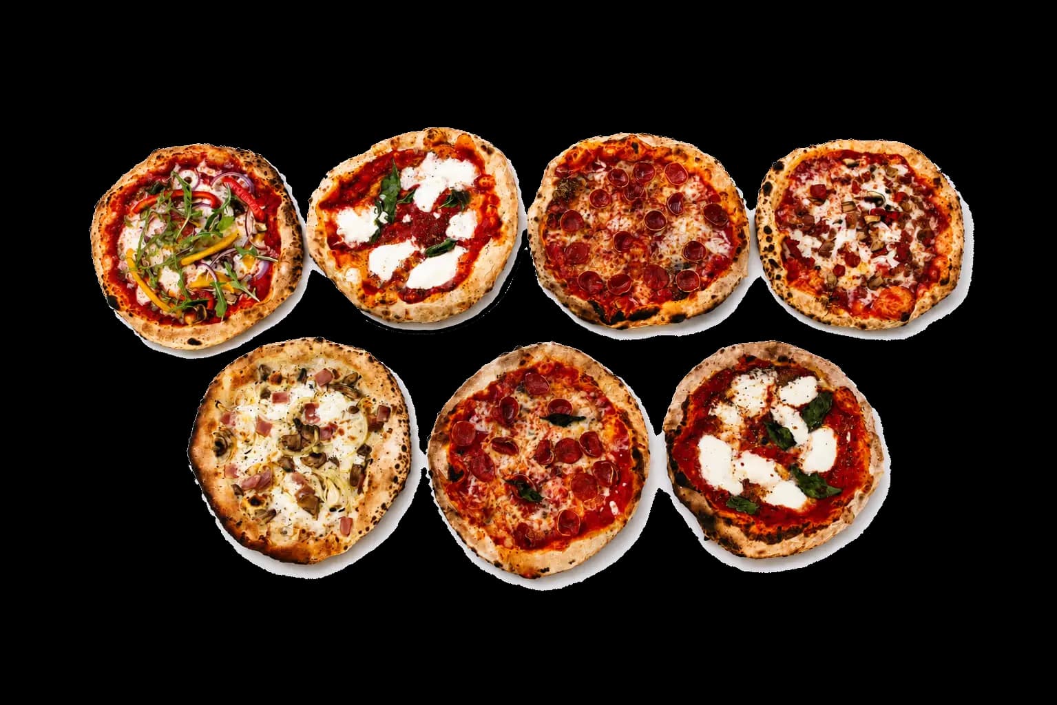Variety of wood-fired pizzas arranged for buffet service